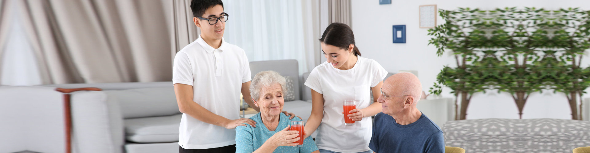 young caregivers assisting the old couple on their meal