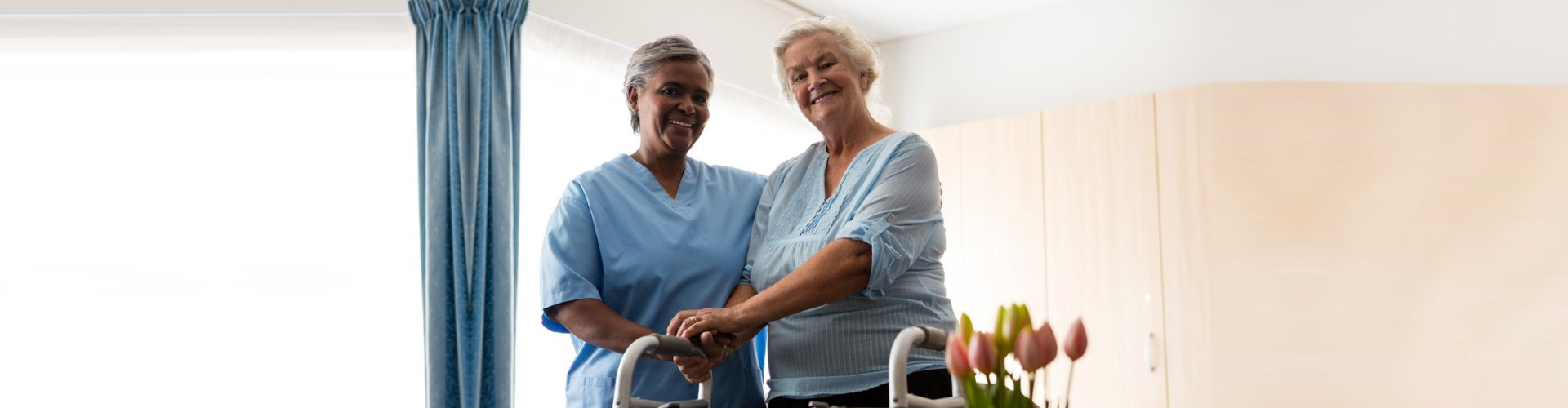 senior woman accompanied by her caregiver